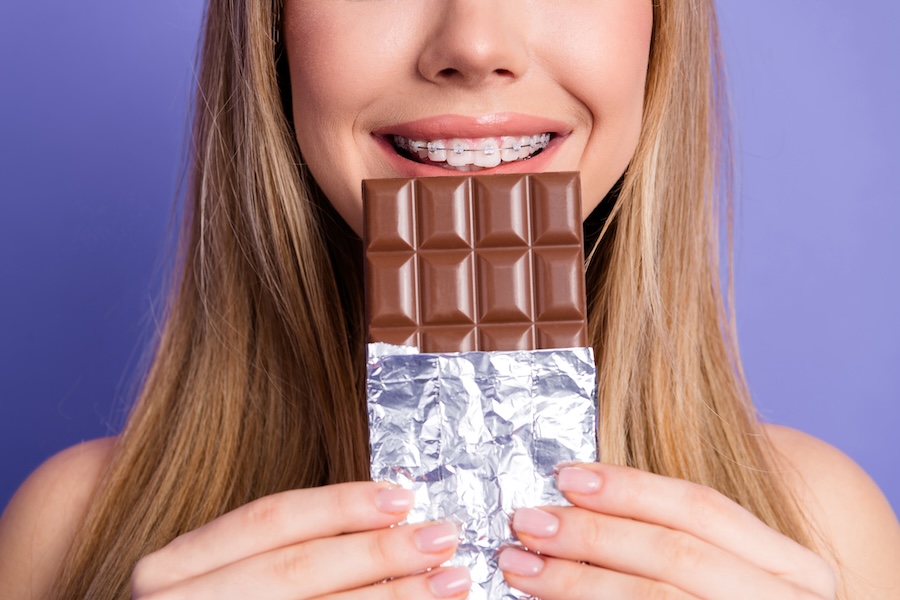 halloween with braces, girl with braces eating chocolate